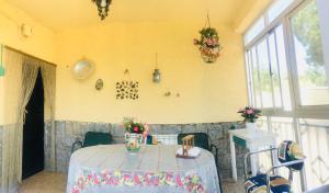 a table in a room with a yellow wall at Los Robles in Ávila