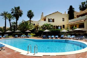 a swimming pool in front of a villa at Las Palmeras 4 with rooftop solarium and fiber optic internet in Atamaría