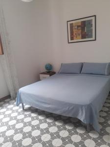a bed in a bedroom with a white wall at Casa Del Parco in Polignano a Mare