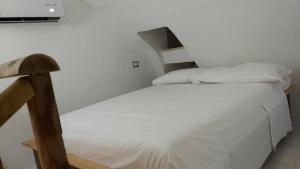 a small bedroom with a bed and a tv on the wall at Vera Vacanza in Sannicola