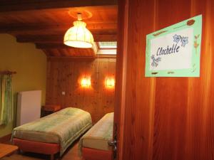 a bedroom with two beds and a sign on the wall at La Boissellerie in Saulxures-sur-Moselotte +13 photos