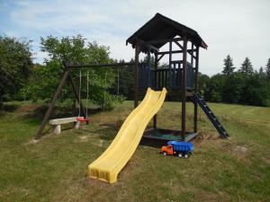a playground with a slide and a play structure at Penzion Starobor in Sedlice