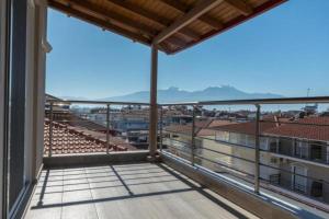 a balcony with a view of a stadium at Ammos Beach Seaside Luxury Suites Hotel in Olympic Beach