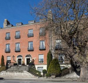 a large red brick building with stairs in front of it at Pembroke Townhouse in Dublin