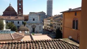 a view of a city with buildings and a clock tower at da Francesco rooms in Lucca