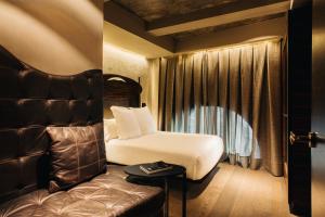 a hotel room with a bed and a window at Hotel Bagués, a Small Luxury Hotel of the World in Barcelona