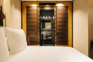 a hotel room with a bed and a mirror at Hotel Bagués, a Small Luxury Hotel of the World in Barcelona