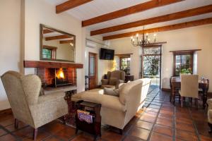 a living room with a couch and a fireplace at De Hoek Manor in Stellenbosch