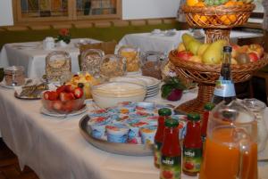 Landgasthof Rößle في Berau: طاولة طعام ومشروبات وسلات فاكهة
