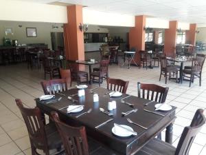 a dining room with a large table and chairs at Bakgatla Resort in Pilanesberg