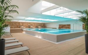 a large swimming pool in a building with a large pool at Adriana Hvar Spa Hotel in Hvar