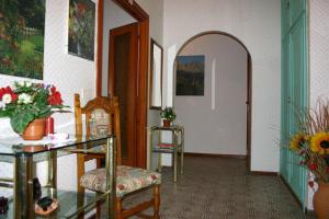 pasillo con mesa, silla y puerta en Albergo Anna en Ciampino