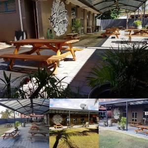 a group of picnic tables in front of a building at Junction Hotel Moora in Moora