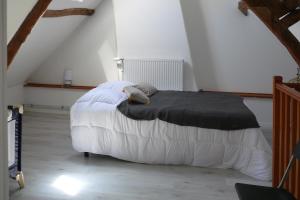 a bedroom with a bed with a black blanket at gite de dominois les gardons in Dominois