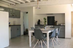a kitchen and dining room with a table and chairs at gite de dominois les gardons in Dominois