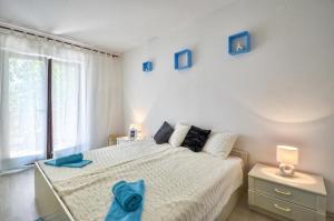 Postel nebo postele na pokoji v ubytování The Big Smile Apartments
