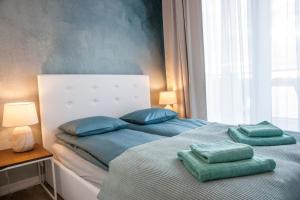 a bedroom with a bed with two pillows on it at Apartament Villa Nautica in Rydzewo