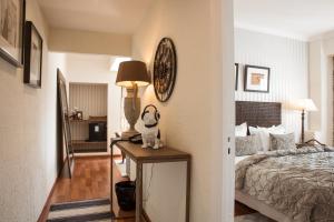 a bedroom with a bed and a stuffed animal on a table at Hotel Feliz in Palma de Mallorca