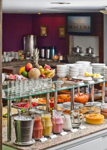 a buffet with many plates of food and fruits at Iracema Travel in Fortaleza