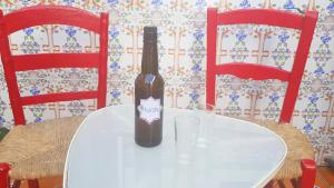 a bottle of wine sitting on a table with two glasses at Casa Algarabía in Sanlúcar de Barrameda