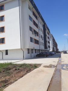 an empty street in front of an apartment building at Studio Apartment in Chiajna