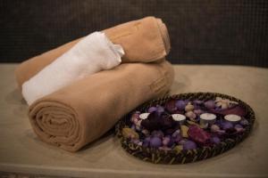 a roll of towels next to a bowl of vegetables at Thassos Grand Resort in Alyki