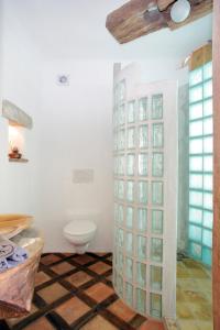 a bathroom with a toilet and a glass wall at Pension Sebastian in Mikulov
