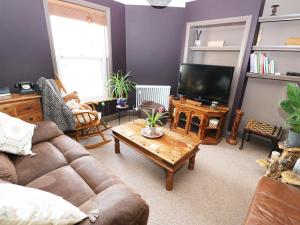 a living room with a couch and a coffee table at Rose Cottage in Great Yarmouth