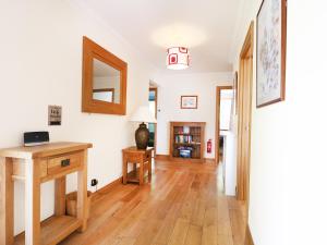 a living room with a table and a mirror at Westhaven in Mallaig