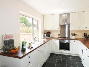 a kitchen with white cabinets and a counter with fruit on it at Starfield in Lincoln