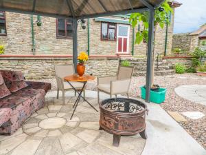 a patio with a couch and a table at The Courtyard in Kington