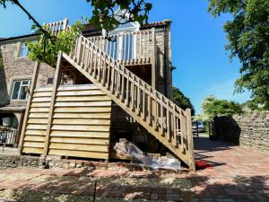 a wooden staircase leading up to a house at The Loft at Lucott House in Bath