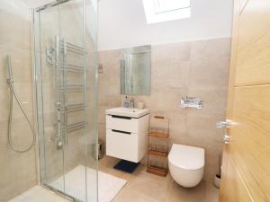 a bathroom with a shower and a toilet and a sink at 7 Ocean Gateway in Hythe +33 photos