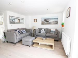 a living room with two couches and a coffee table at 7 Ocean Gateway in Hythe