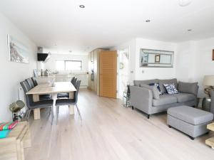 a living room with a table and a couch at 7 Ocean Gateway in Hythe