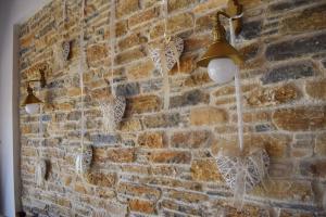 a brick wall with two lights on it at Mando Beachfront in Stafylos