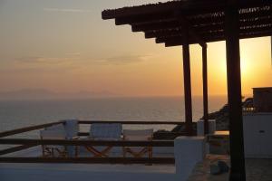 a view of the ocean at sunset from a resort at Antiparos Vibes in Agios Georgios