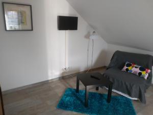 a living room with a couch and a table at Pension Holmer Moorhof in Hartenholm