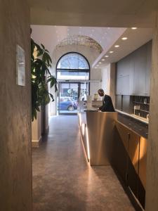 a man sitting at a counter in a kitchen at Hotel Aphrodite in Rome