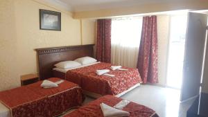 a hotel room with two beds and a window at Florin Hotel in Istanbul +30 photos