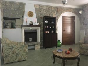 a living room with a table and a fireplace at Portico degli amori in Lettomanoppello