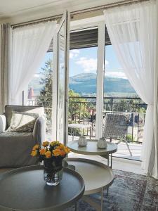 a living room with a couch and a large window at Apartamenty Magnum in Szklarska Poręba