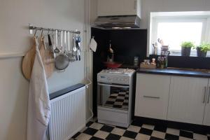 uma cozinha com fogão e piso em xadrez em Het Huis tussen Kerk en Klooster em Ootmarsum