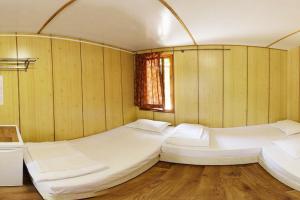 a room with two beds and a window at Бунгала Калина - Нестинарка in Tsarevo