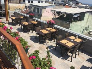 an outdoor patio with tables and chairs and flowers at Laleli Gonen Hotel in Istanbul
