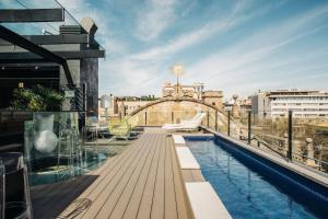 a balcony with a swimming pool on top of a building at Hotel Bagués, a Small Luxury Hotel of the World in Barcelona