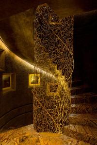 a stairway with a patterned wall and a spiral staircase at Hotel Bagués, a Small Luxury Hotel of the World in Barcelona
