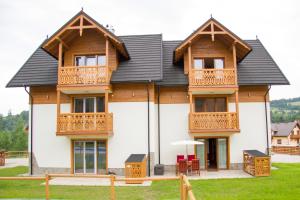 a large house with wooden balconies on it at Apartament Góralka in Jaworki