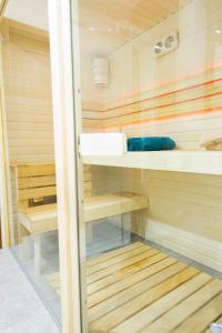 a sauna with wooden shelves and a glass door at Apartament Góralka in Jaworki +13 photos