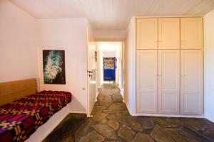 a bedroom with a bed and a closet at Stone house with a magical view in Otzias